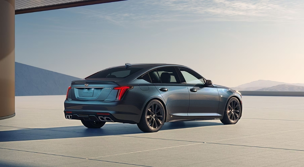 A blue 2025 Cadillac CT5, a popular Cadillac for sale near Belle Plaine, is shown from a rear angle.
