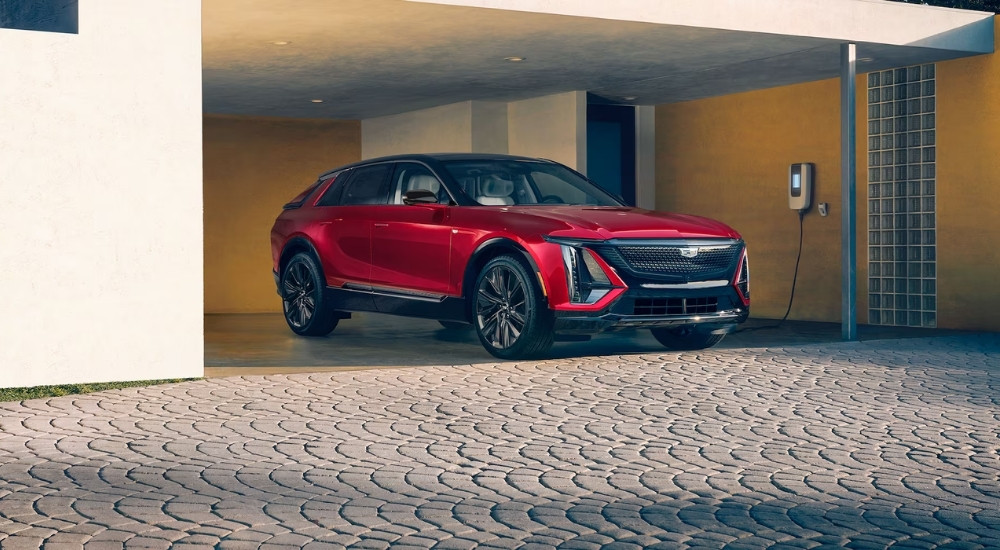 A red 2025 Cadillac LYRIQ for sale near Minneapolis is shown charging.