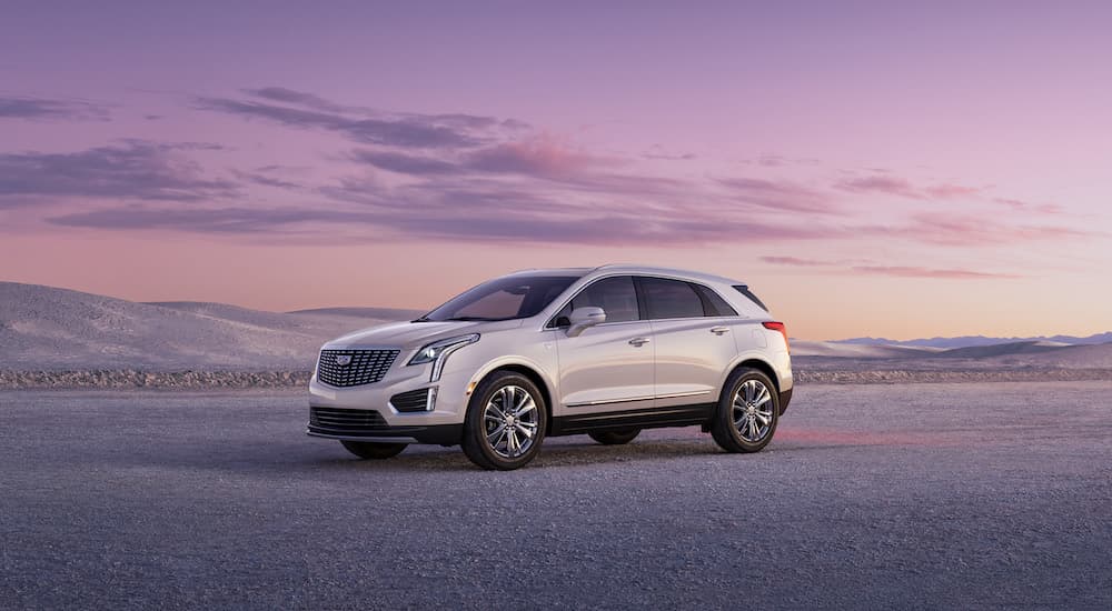 A white 2025 Cadillac XT5 from the side.