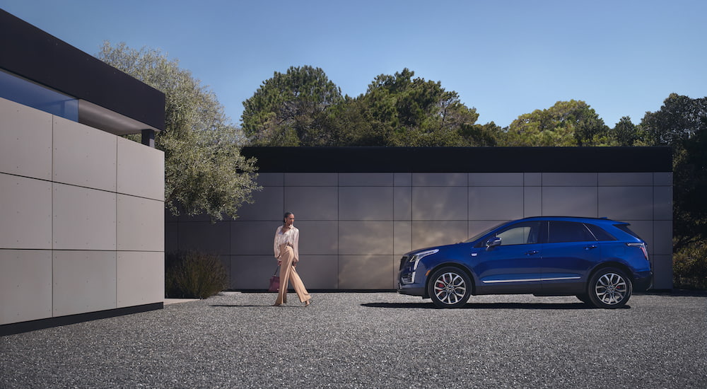 A blue 2025 Cadillac XT5 from the side.
