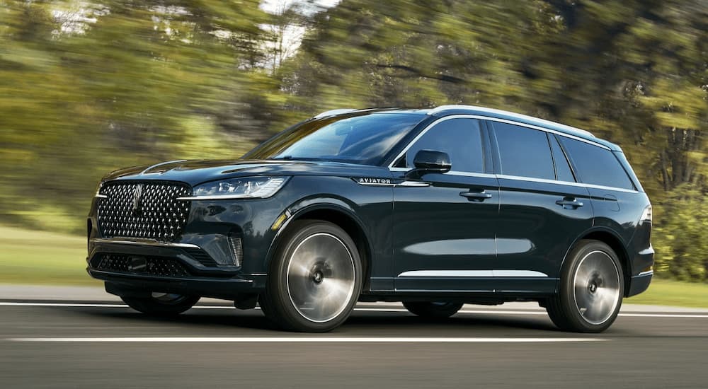 Green 2025 Lincoln Aviator  driving on an open road
