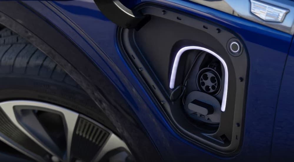 Close-up of the charge port on a blue 2026 Cadillac VISTIQ.