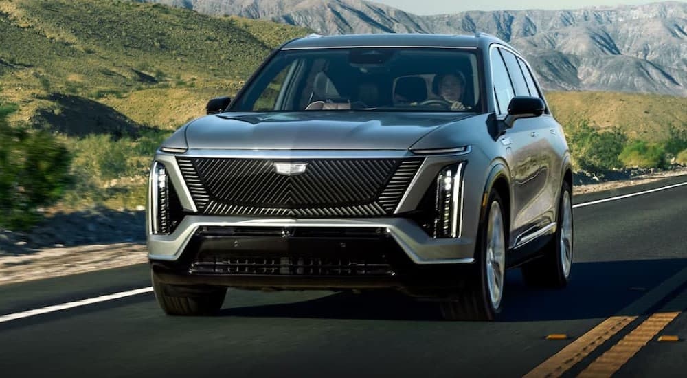 A silver 2026 Cadillac VISTIQ driving to a dealer near Shakopee.