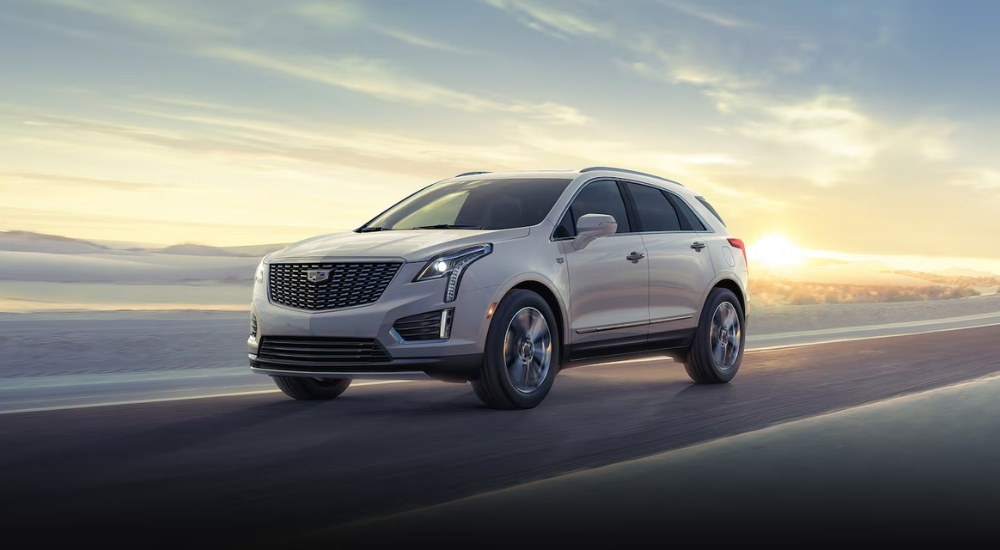 White 2026 Cadillac XT5 driving on an open road