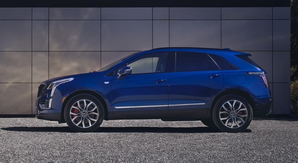 Blue 2026 Cadillac XT5 parked in front of a wall
