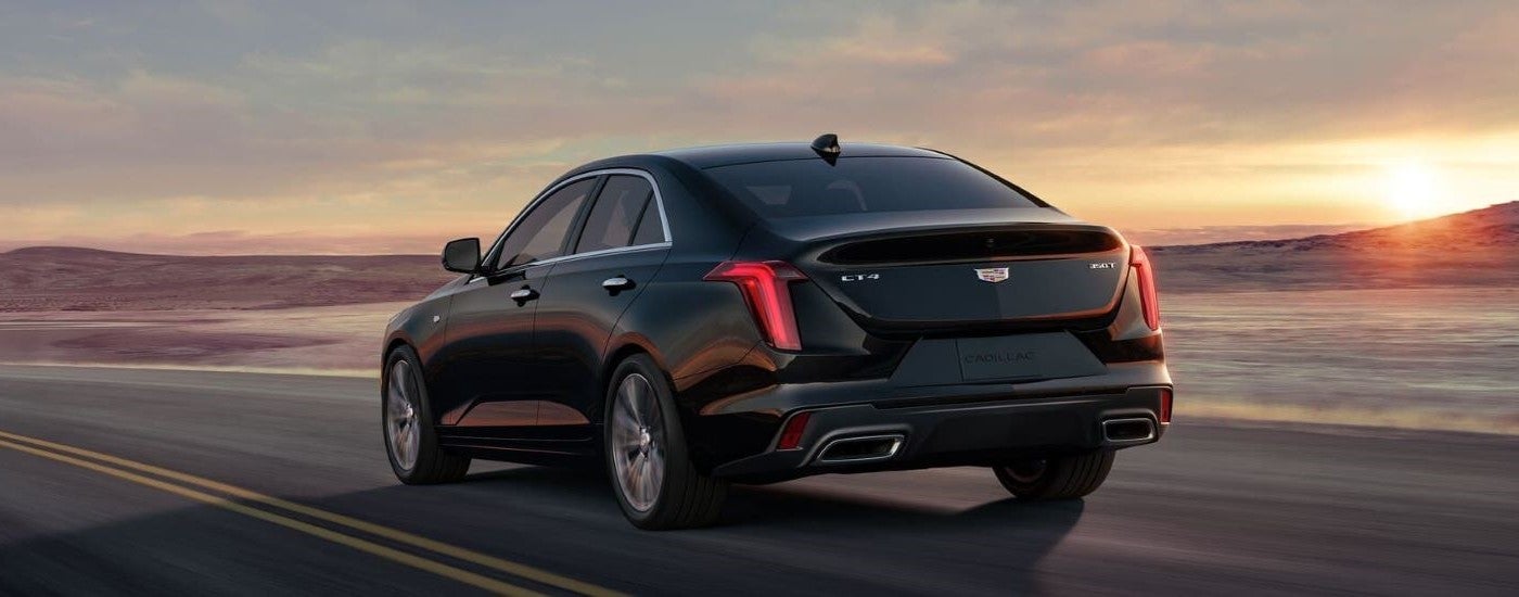 Black 2023 Cadillac CT4 Sport driving down an open road