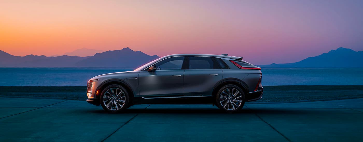 Grey 2023 Cadillac LYRIQ parked in front of mountains