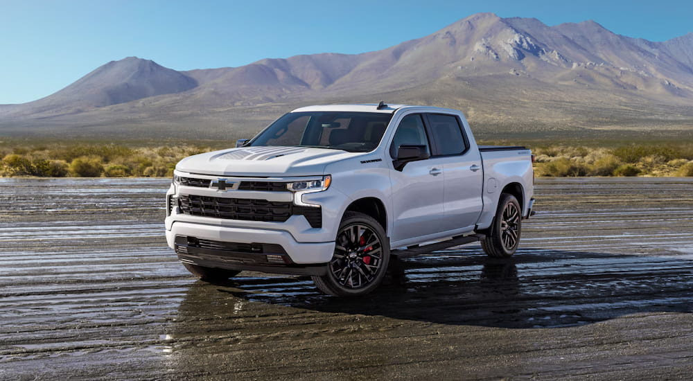 2023 Chevy Silverado 1500 driving on a muddy road.