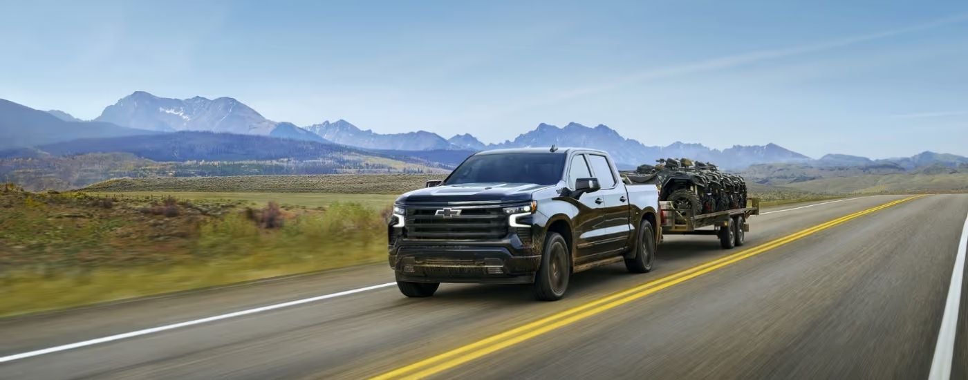A black 2025 Chevy Silverado 1500 from the front.
