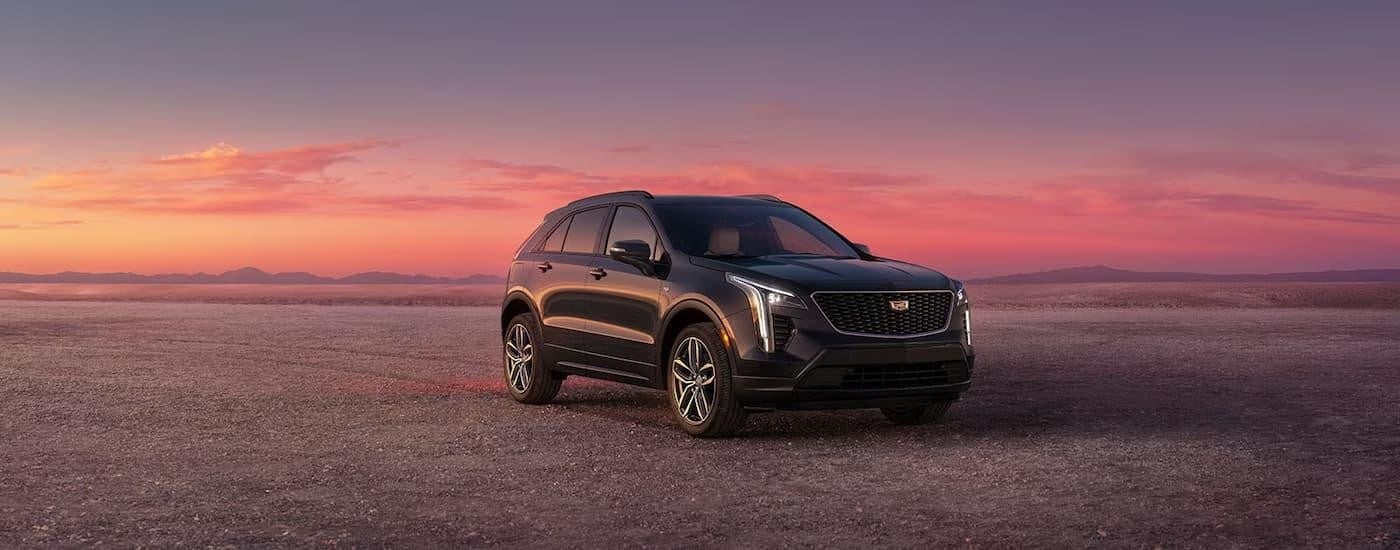 A grey 2023 Cadillac XT4 is shown parked in an open area after leaving a Cadillac dealer serving Owatonna.