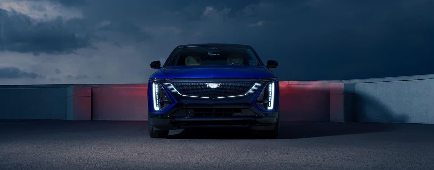 A blue 2025 Cadillac LYRIQ is parked on top of a rooftop garage center.