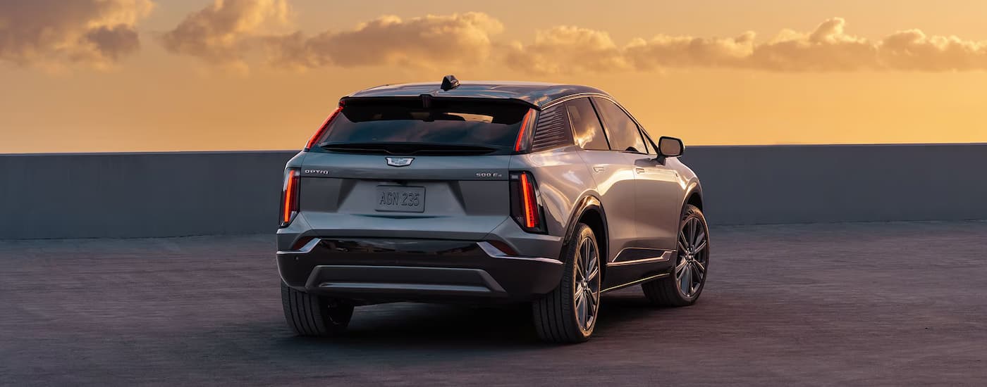 A rear view of a 2025 Cadillac OPTIQ parked on top of a rooftop.