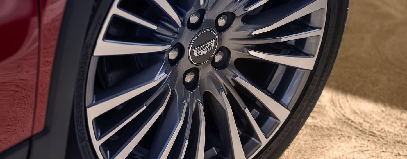 A close up of the rim on a red 2024 Cadillac XT4 for sale.