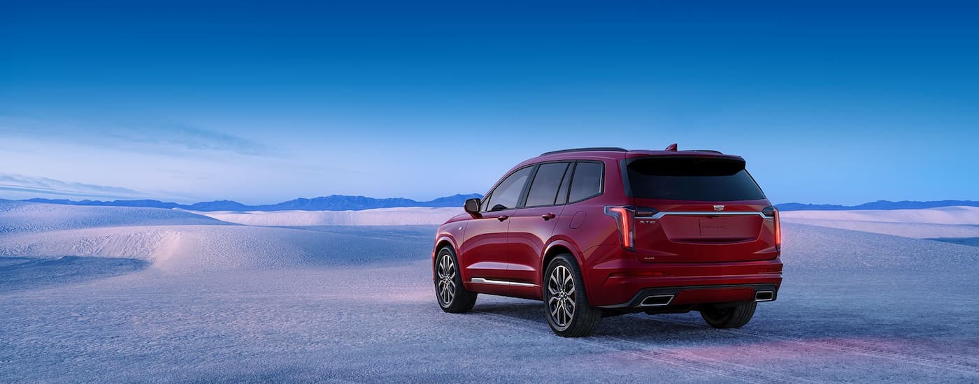 Rear of a red 2025 Cadillac XT6 parked in a desert.