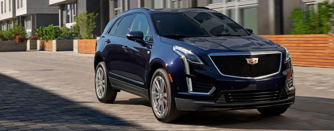 A blue 2023 Cadillac XT5 is shown from the front at an angle.