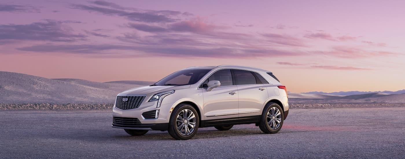 A white 2023 Cadillac XT5 is shown from the side after leaving a Cadillac dealer near Rochester.