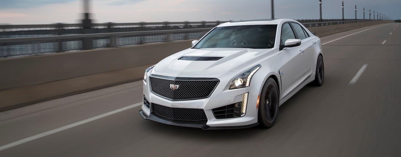 A white 2018 Cadillac CTS-V is driving on a highway.